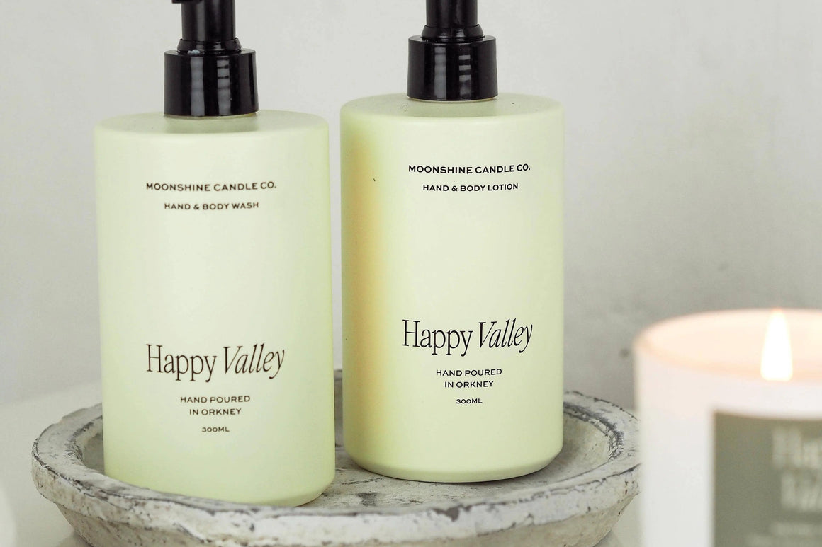 Happy Valley hand and body wash and hand and body lotion in pale yellow dispensers