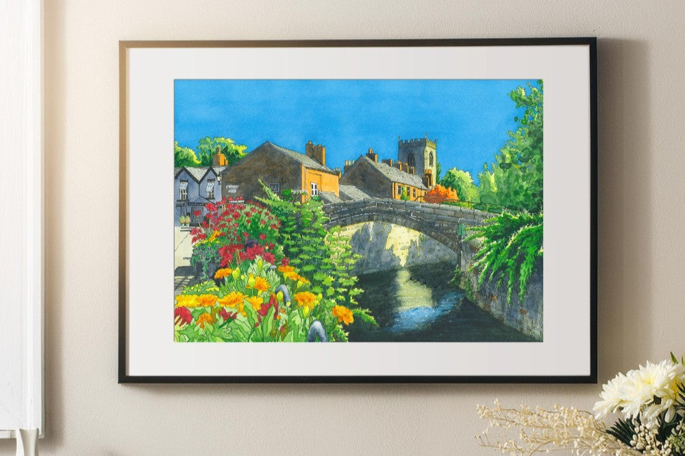 Framed picture on a wall of croston bridge with flowers