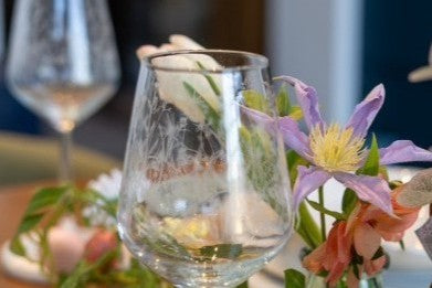 Emma Britton etched wine glasses surrounded by fresh flowers