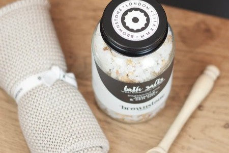 Jar of bath salts with beige coloured cloth