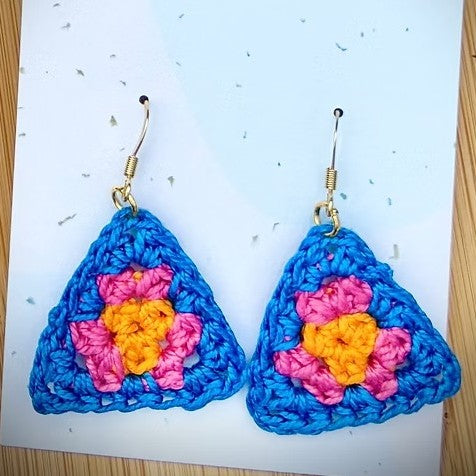 Pink crocheted triangle earrings by Cesca and Woodrow, handcrafted jewelry with a stylish geometric design.