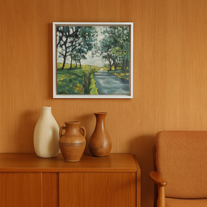 Framed landscape painting above a wooden cabinet with decorative vases and a chair.