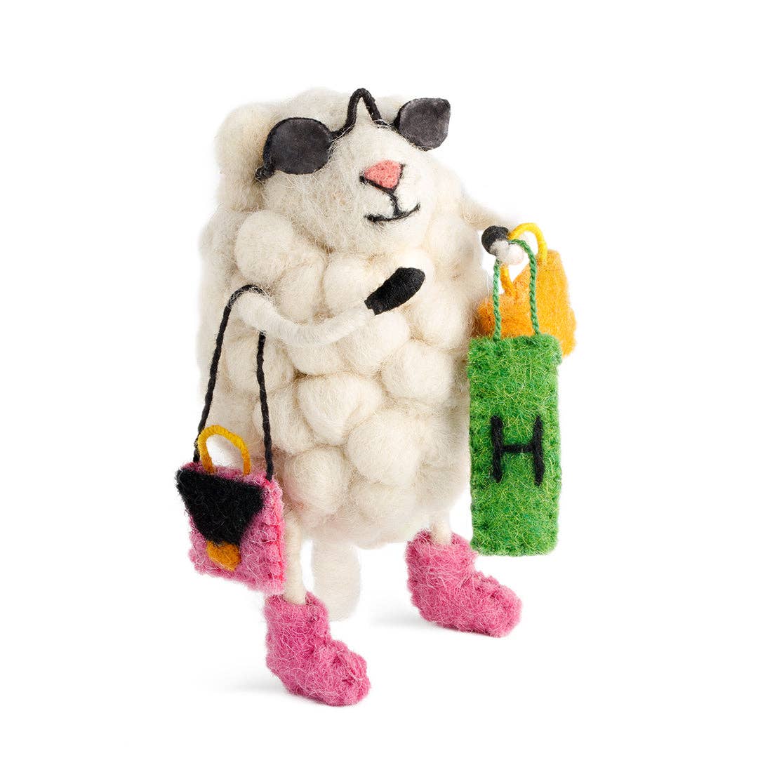 White cat-shaped toy with black ears, pink paws, and colorful bags on a white background
