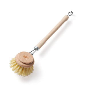 Dish brush with wooden handle and head on a white background