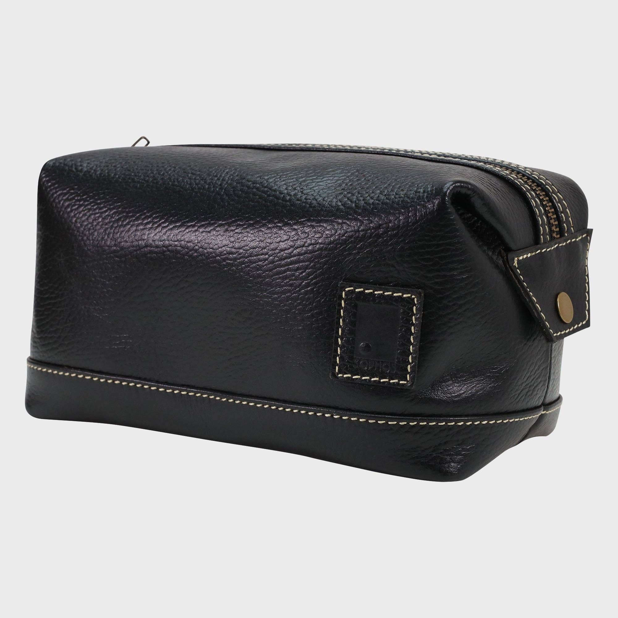 Black leather toiletry bag with gold stitching on a white background