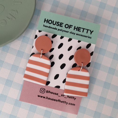 House of Hetty lightweight polymer clay stripy arch dangle earrings hanging with vibrant colors and modern design.