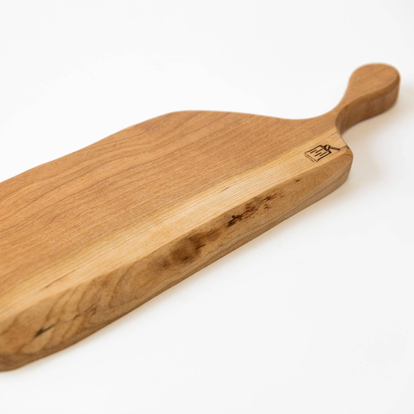Wooden cutting board with handle on a white background