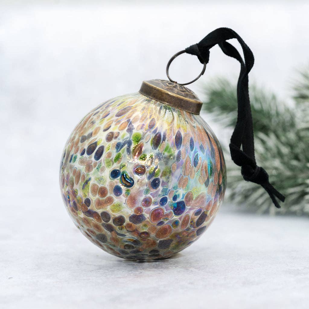 Decorative glass ornament with pebble pattern on a white background