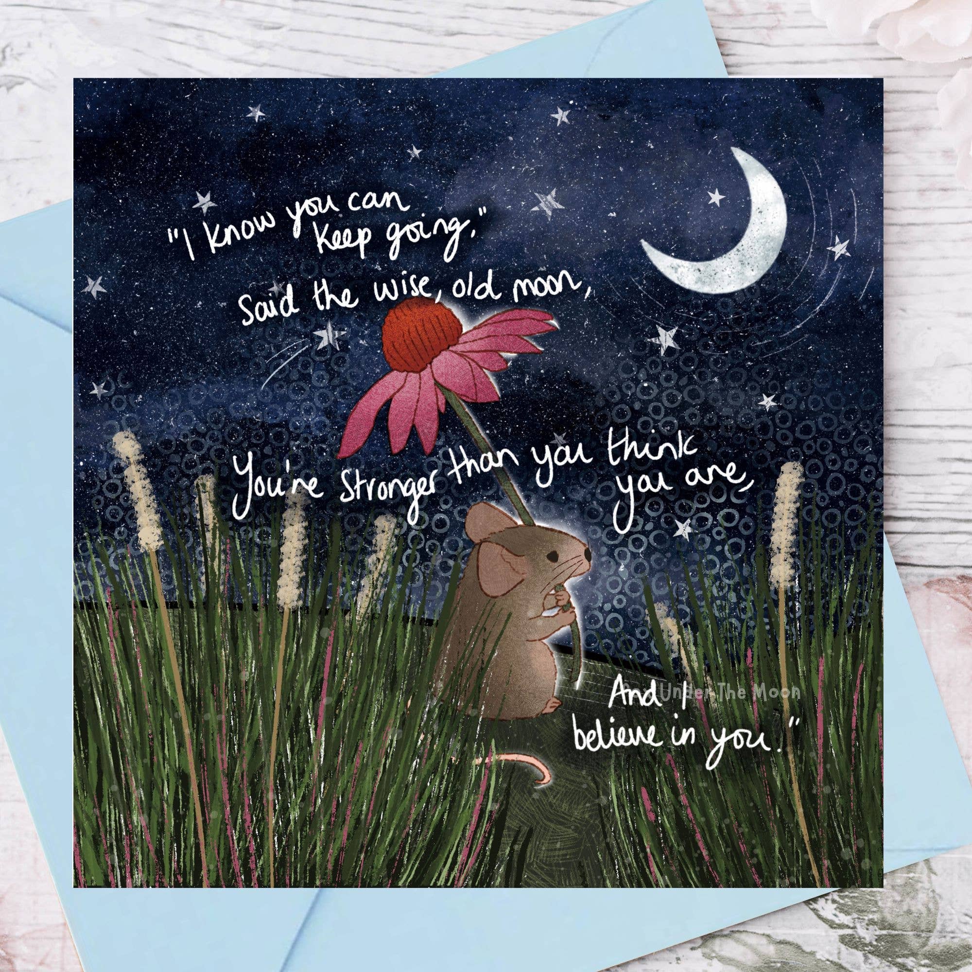 Greeting card with a mouse, flower, and motivational quote against a night sky.