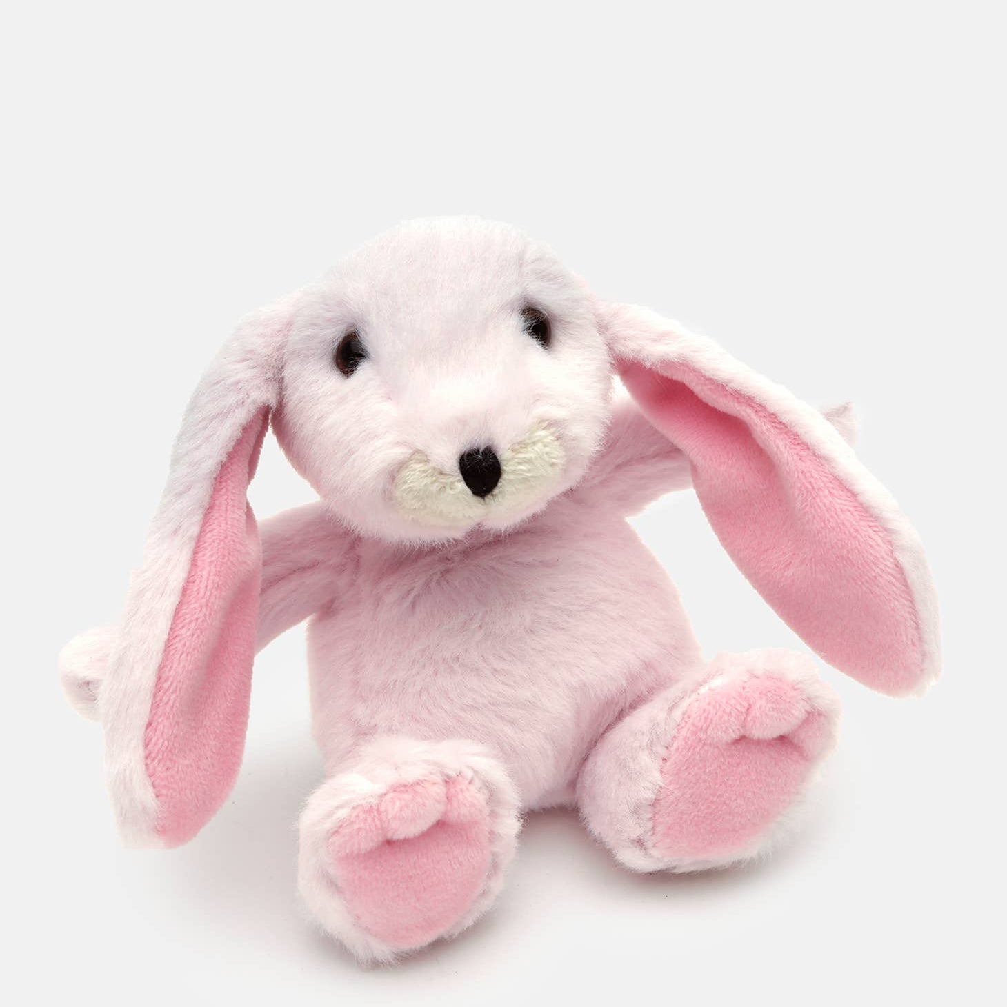 Pink plush bunny toy on a white background