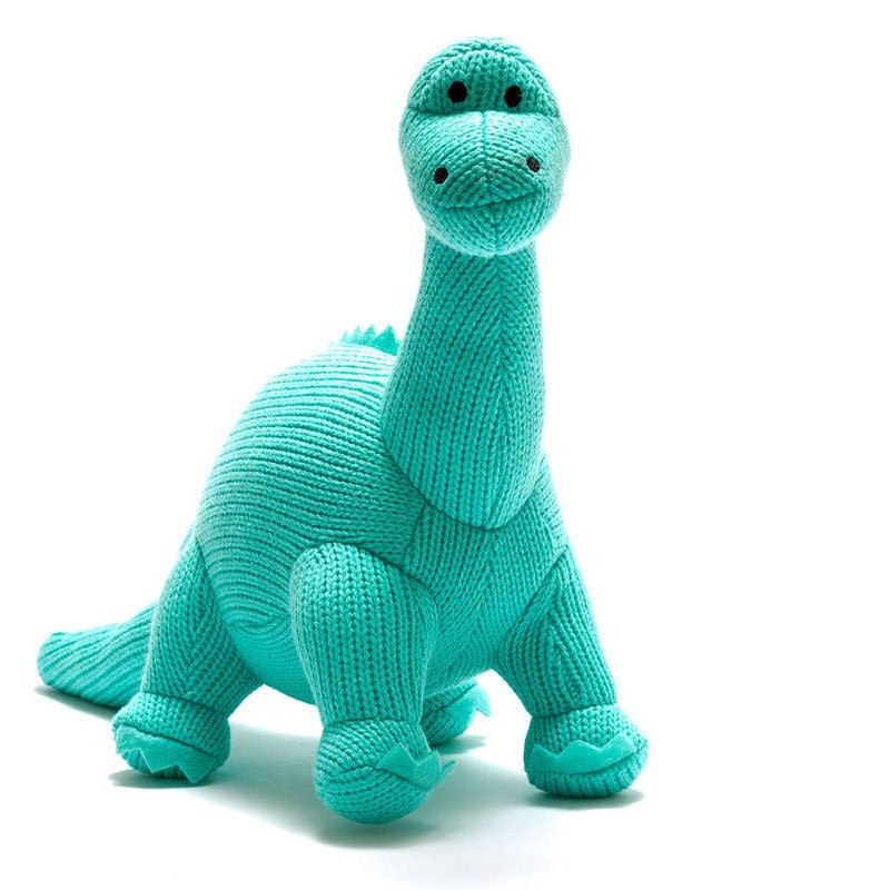 Knitted dinosaur toy in teal color on a white background