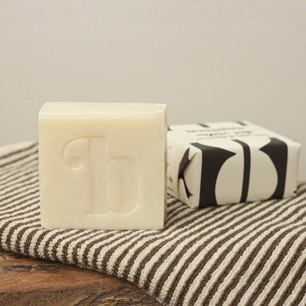Bar of soap with a brand logo on a striped towel
