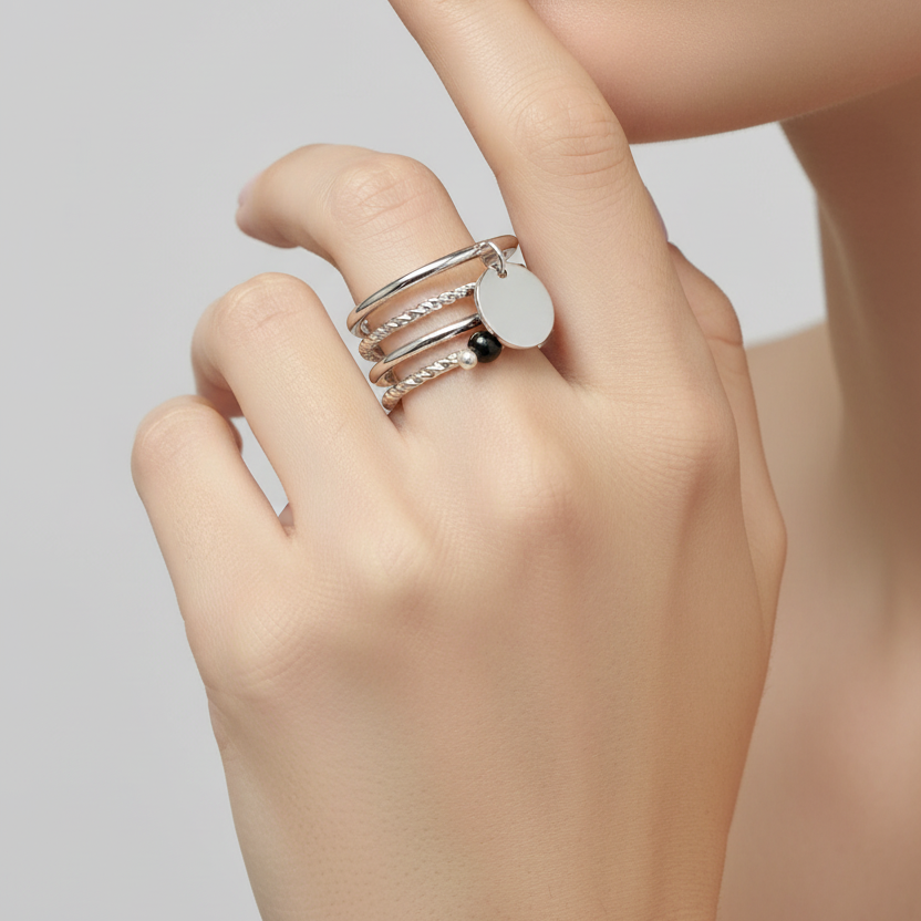 Set of silver rings with various designs on a white background
