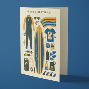 Birthday card with beach-themed illustrations on a blue background