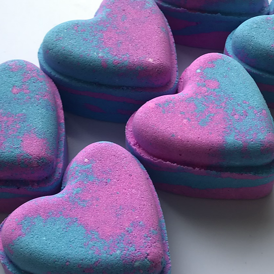 Heart-shaped bath bombs with blue and pink colors on a white background