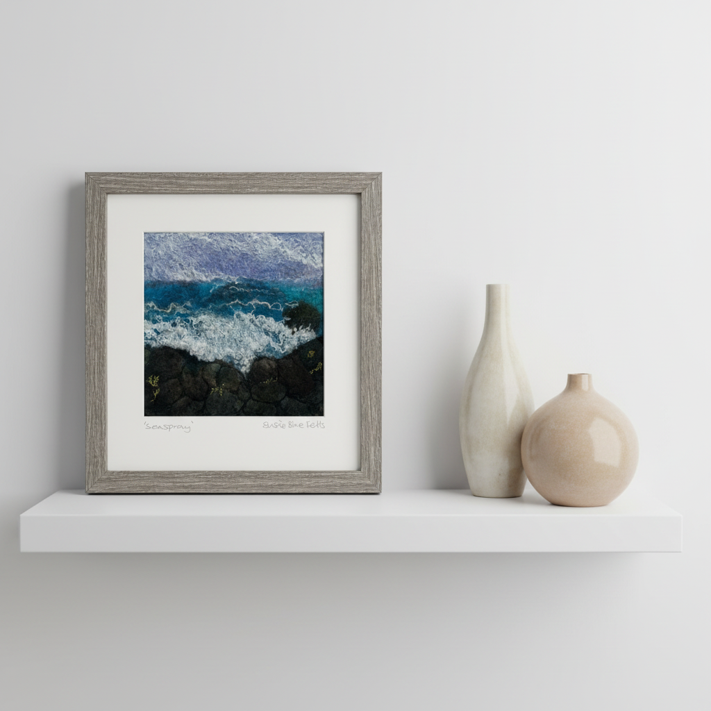 Blue sea scene made of felt on a shelf with 2 vases