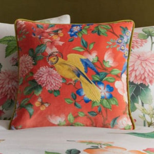 Floral and bird patterned cushions on a sofa