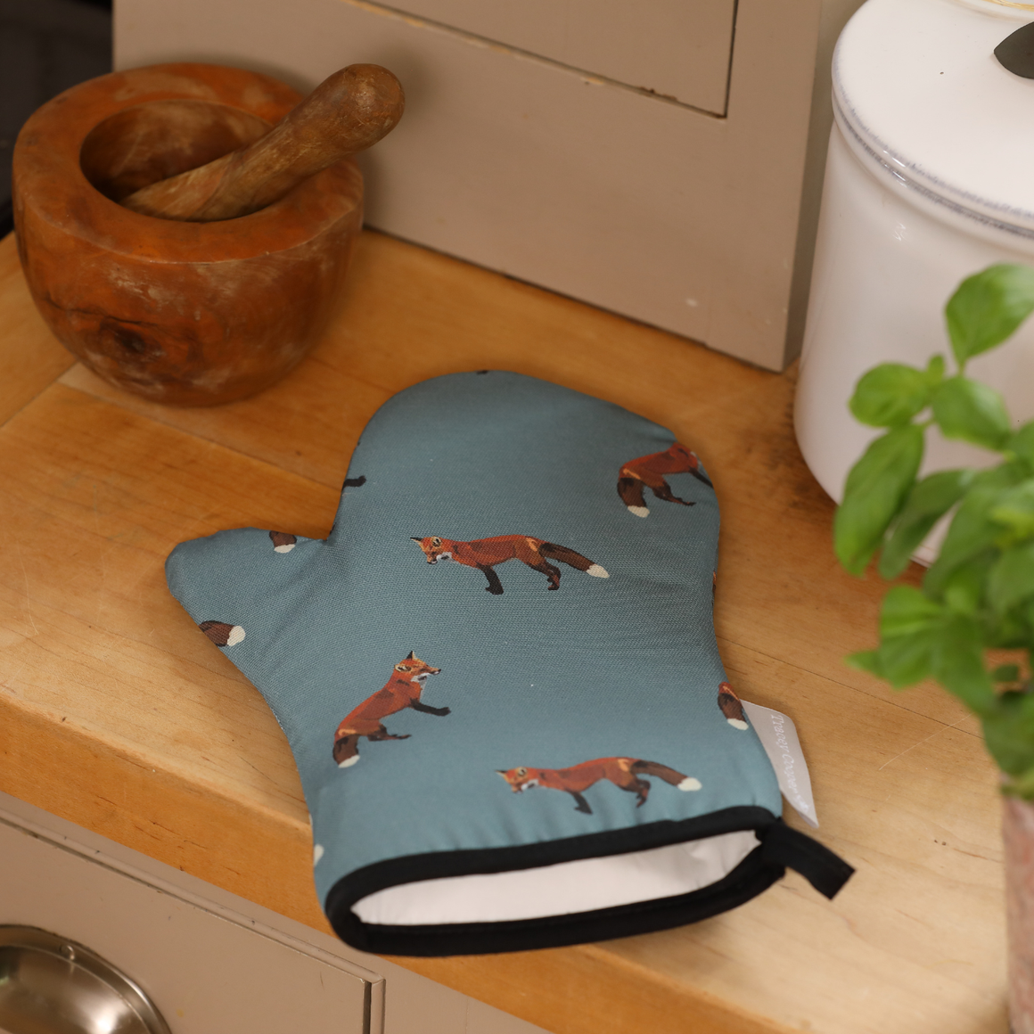 Oven mitt with fox pattern on a kitchen counter