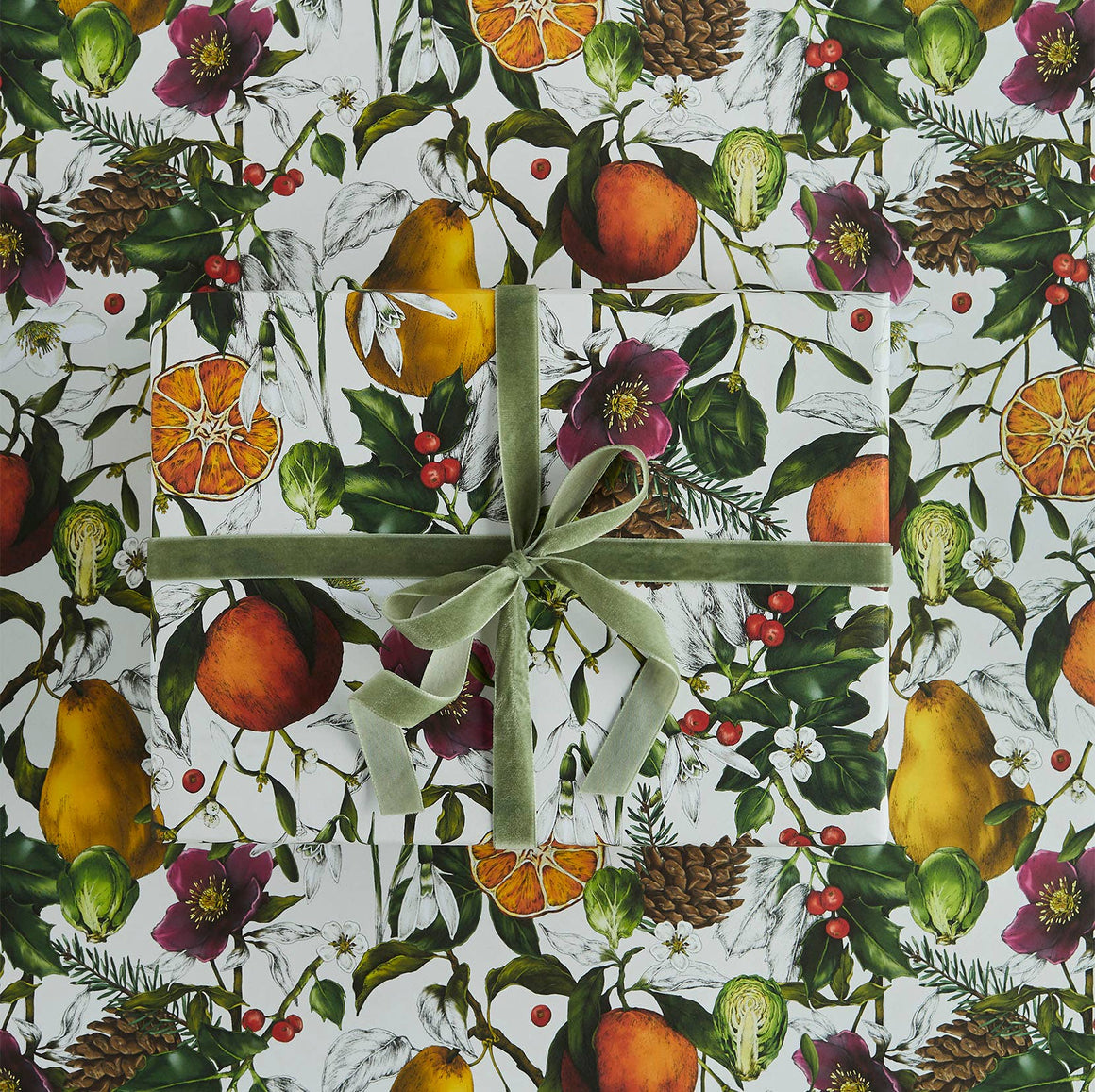 Gift wrapped in a decorative paper with fruits, flowers, and leaves on a white background