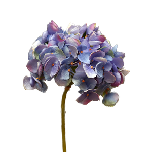 Purple artificial flower arrangement on a white background