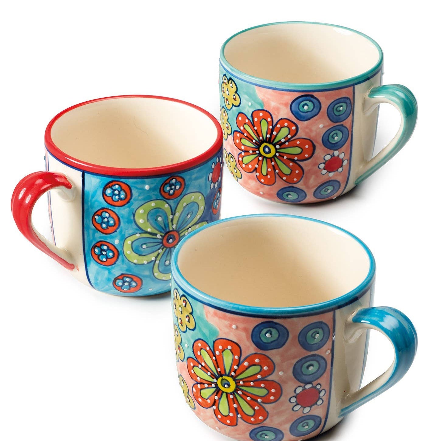 Three colorful ceramic mugs with floral patterns on a white background