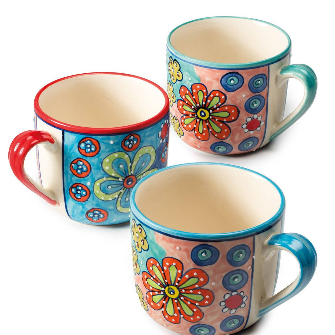 Three colorful ceramic mugs with floral patterns on a white background