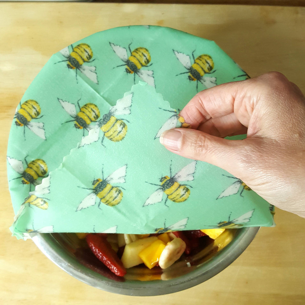 Handmade sustainable beeswax wraps by Honey Bee Good, UK-made, featuring colorful patterns and soft beeswax-coated fabric.