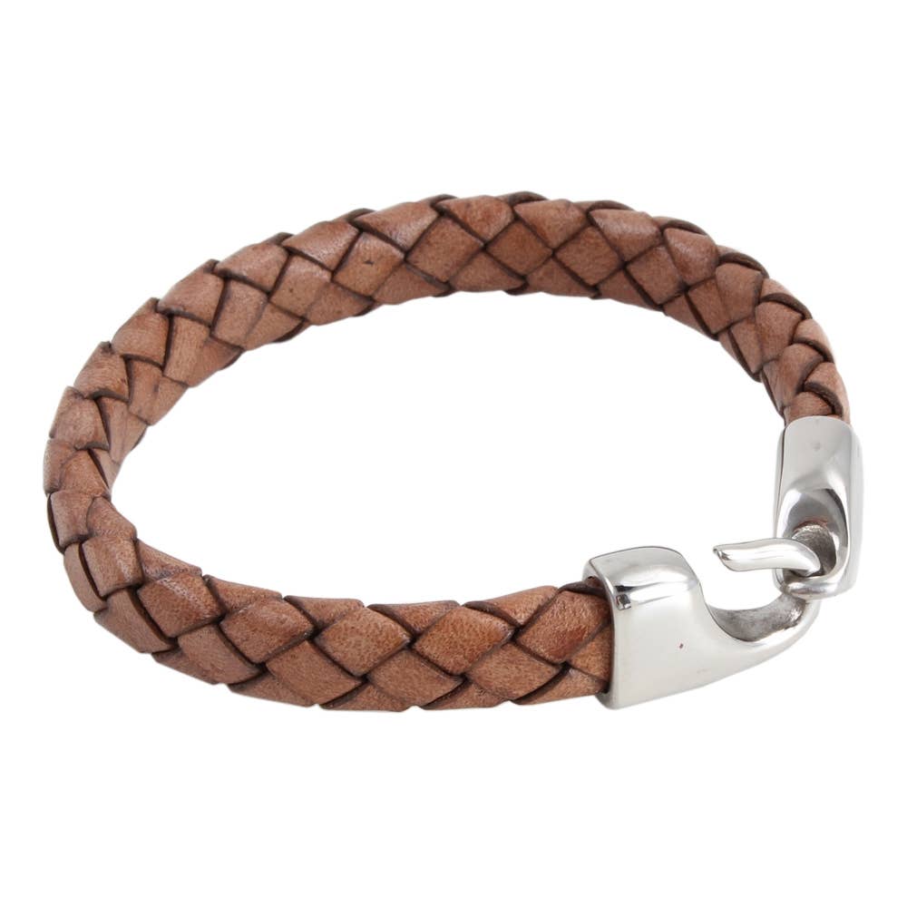 Brown braided leather bracelet with a silver clasp on a white background