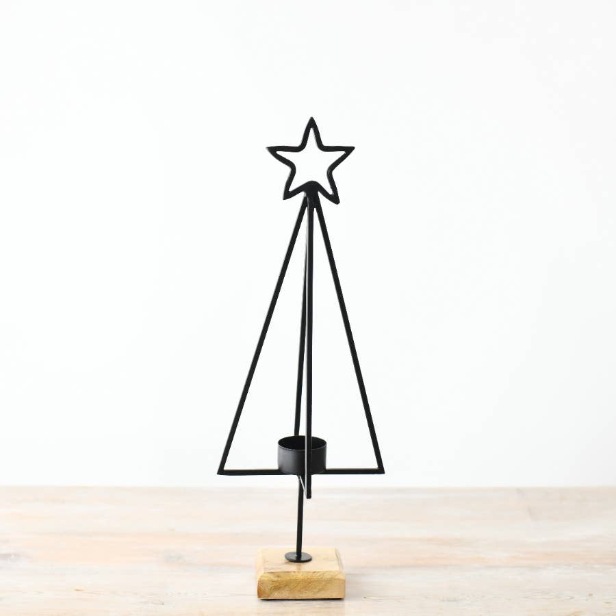 Black metal Christmas tree with star on top and wooden base on a white background