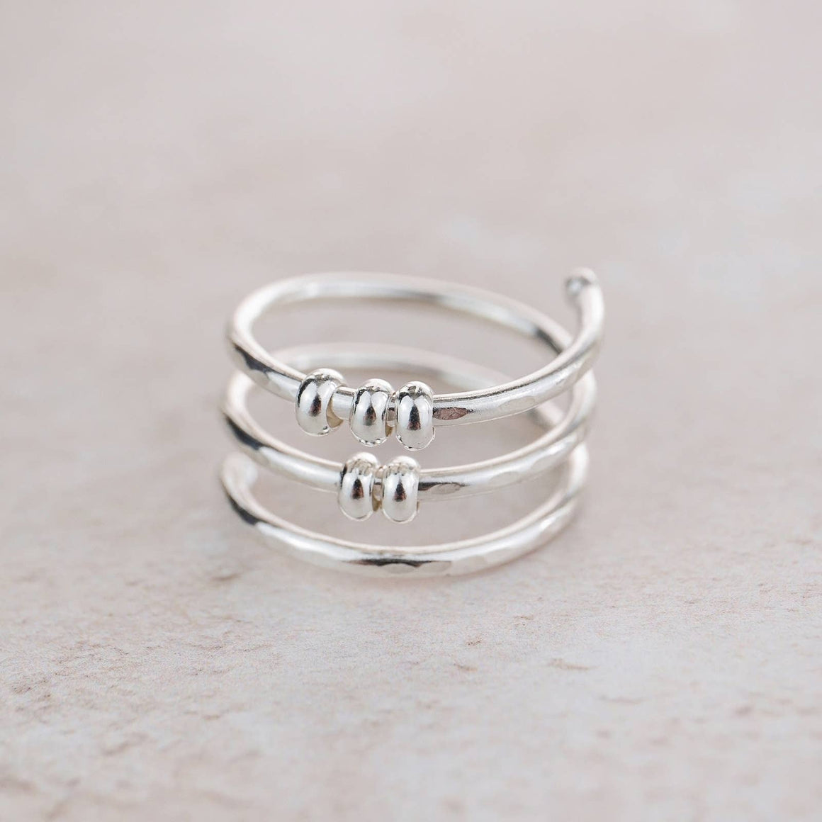 Sterling silver beaded fidget ring by Lucy Kemp Jewellery, featuring textured round beads on a sleek band.