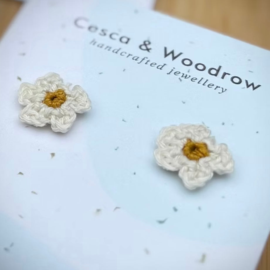 Pink crochet daisy stud earrings by Cesca and Woodrow, featuring hand-crafted floral design and silver posts.