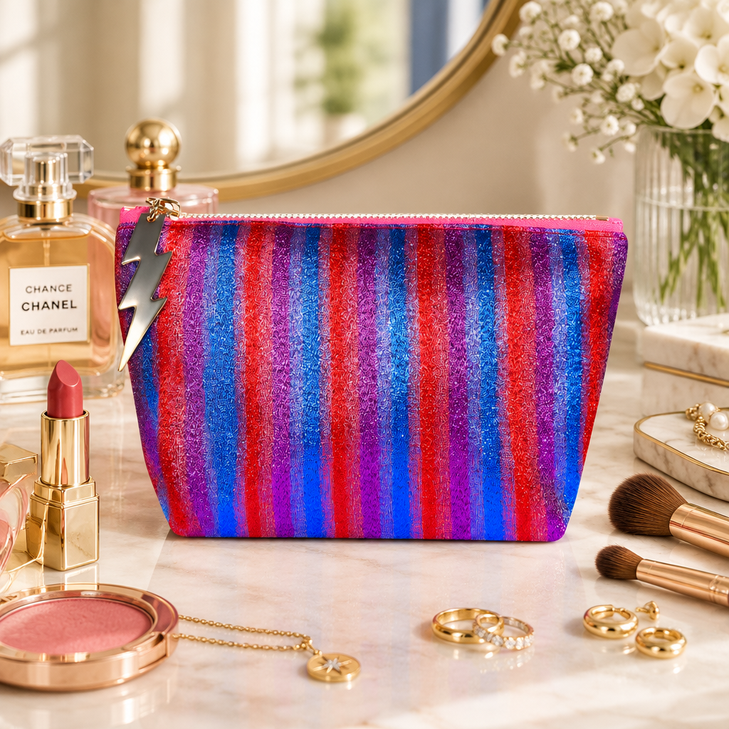 Small disco stripe cosmetic bag by Cockatoo with colorful striped pattern and zipper closure.