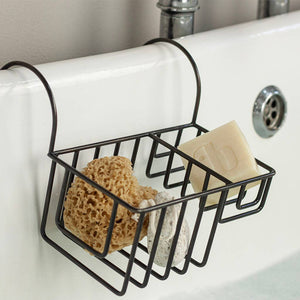 Black wire caddy with sponges and soap on a bathroom sink.