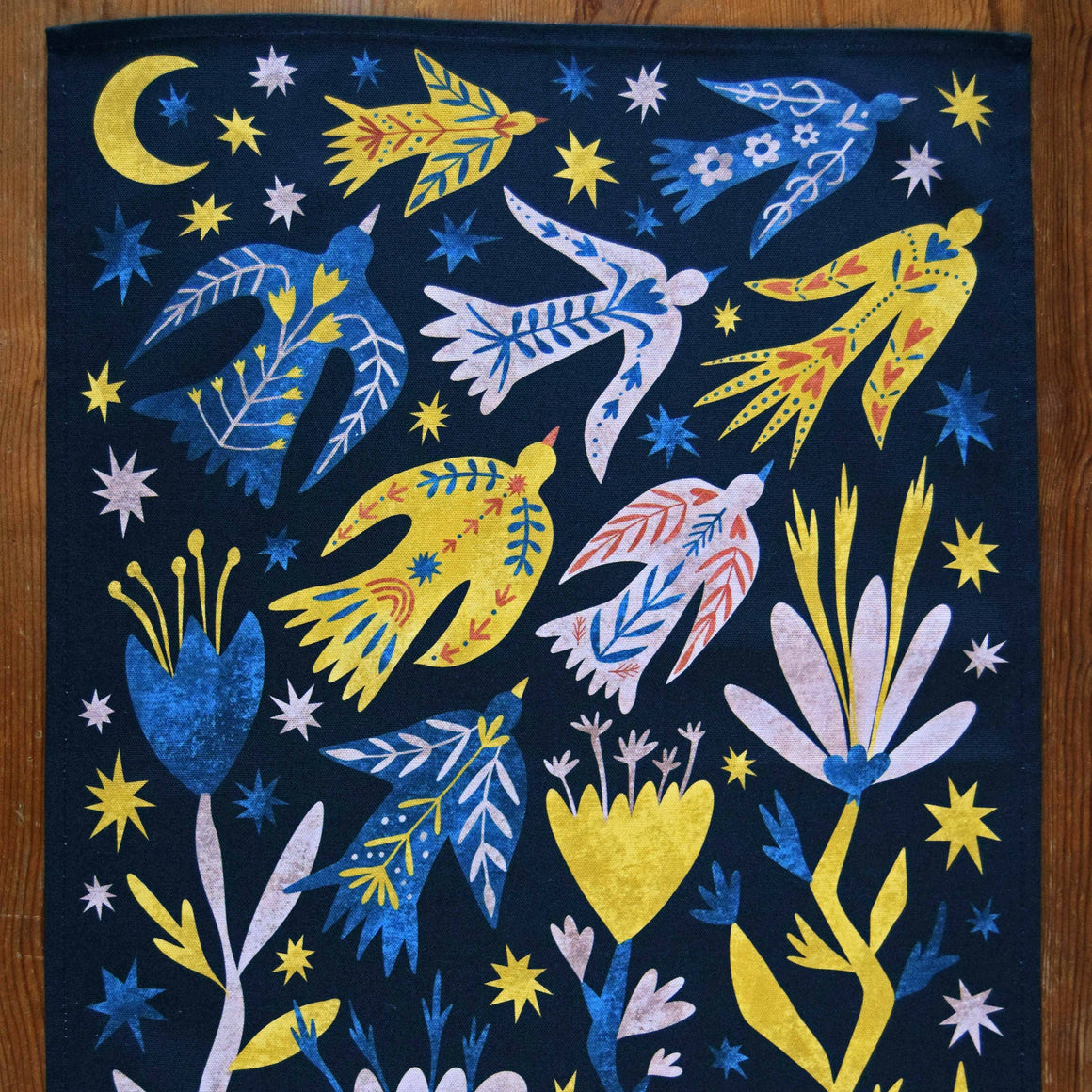 Colorful artwork with birds, flowers, and stars on a dark background
