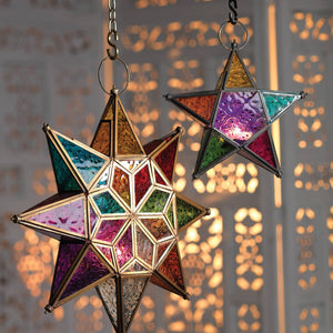 Colorful star-shaped lanterns hanging against a blurred light background