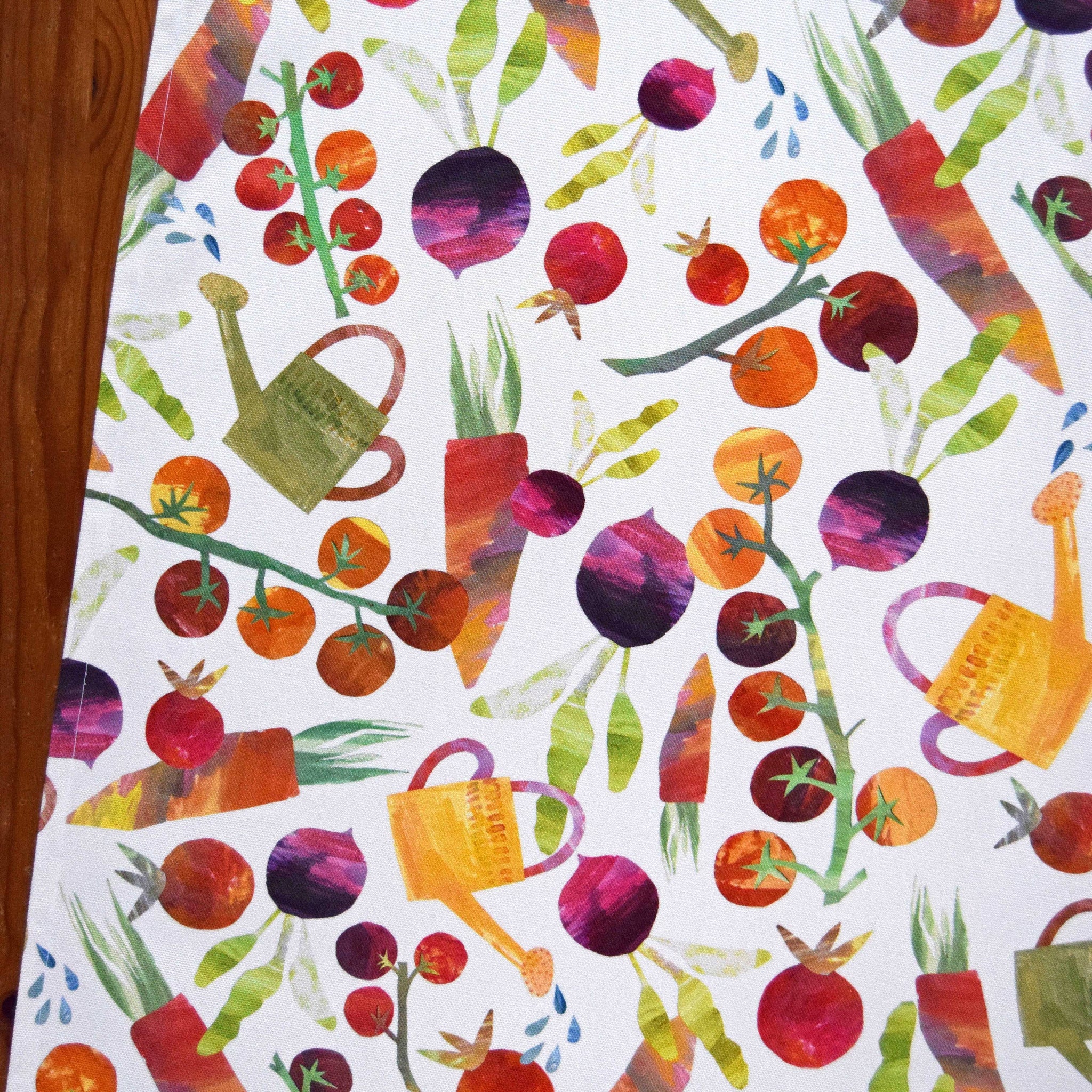 Colorful pattern of vegetables and watering cans on a white background