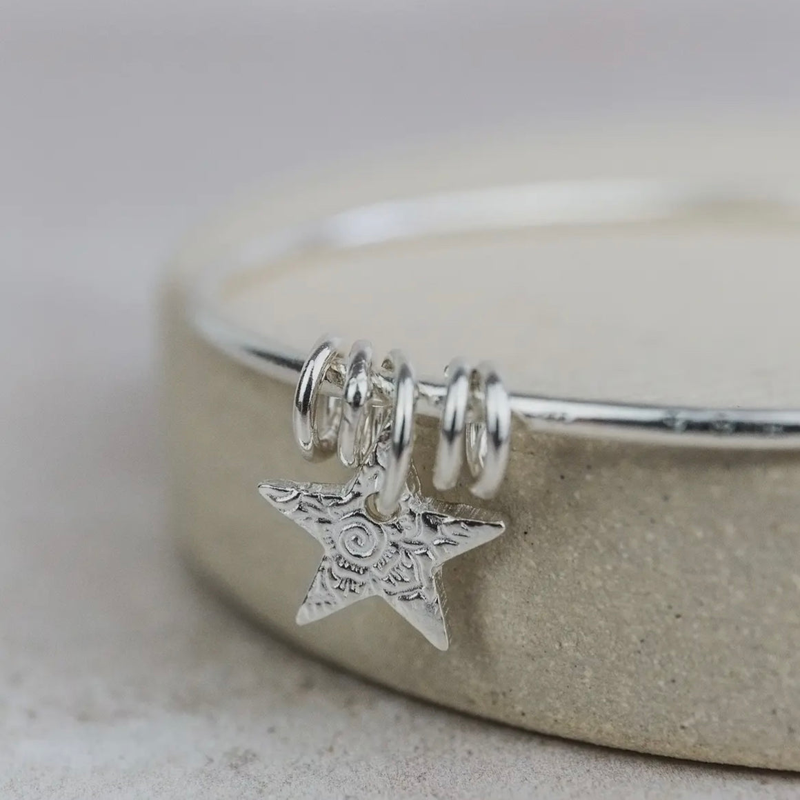 STERLING SILVER TEXTURED STAR CHARM BANGLE BY LUCY KEMP - Feather & Twigs