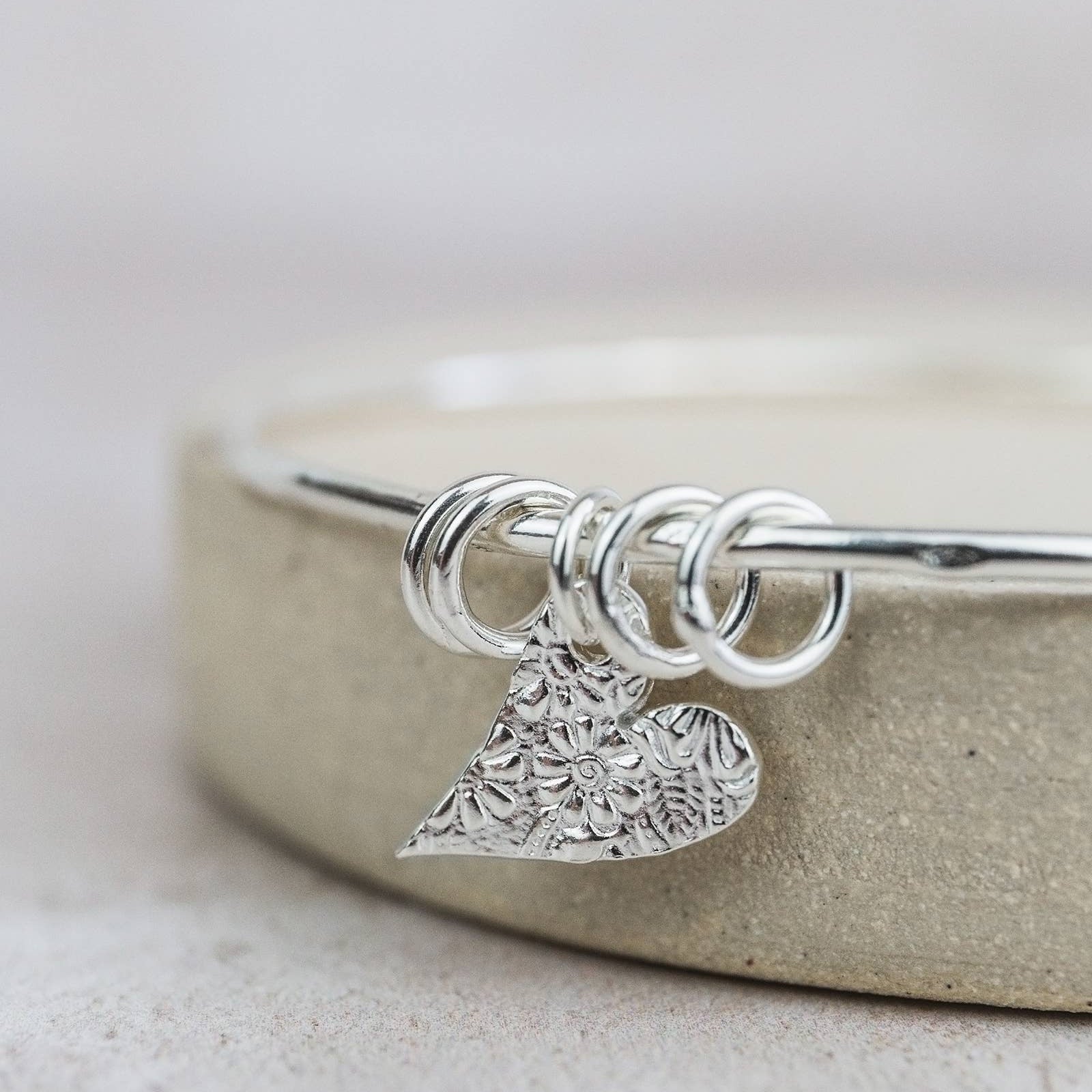STERLING SILVER TEXTURED TILTED HEART CHARM BANGLE BY LUCY KEMP - Feather & Twigs