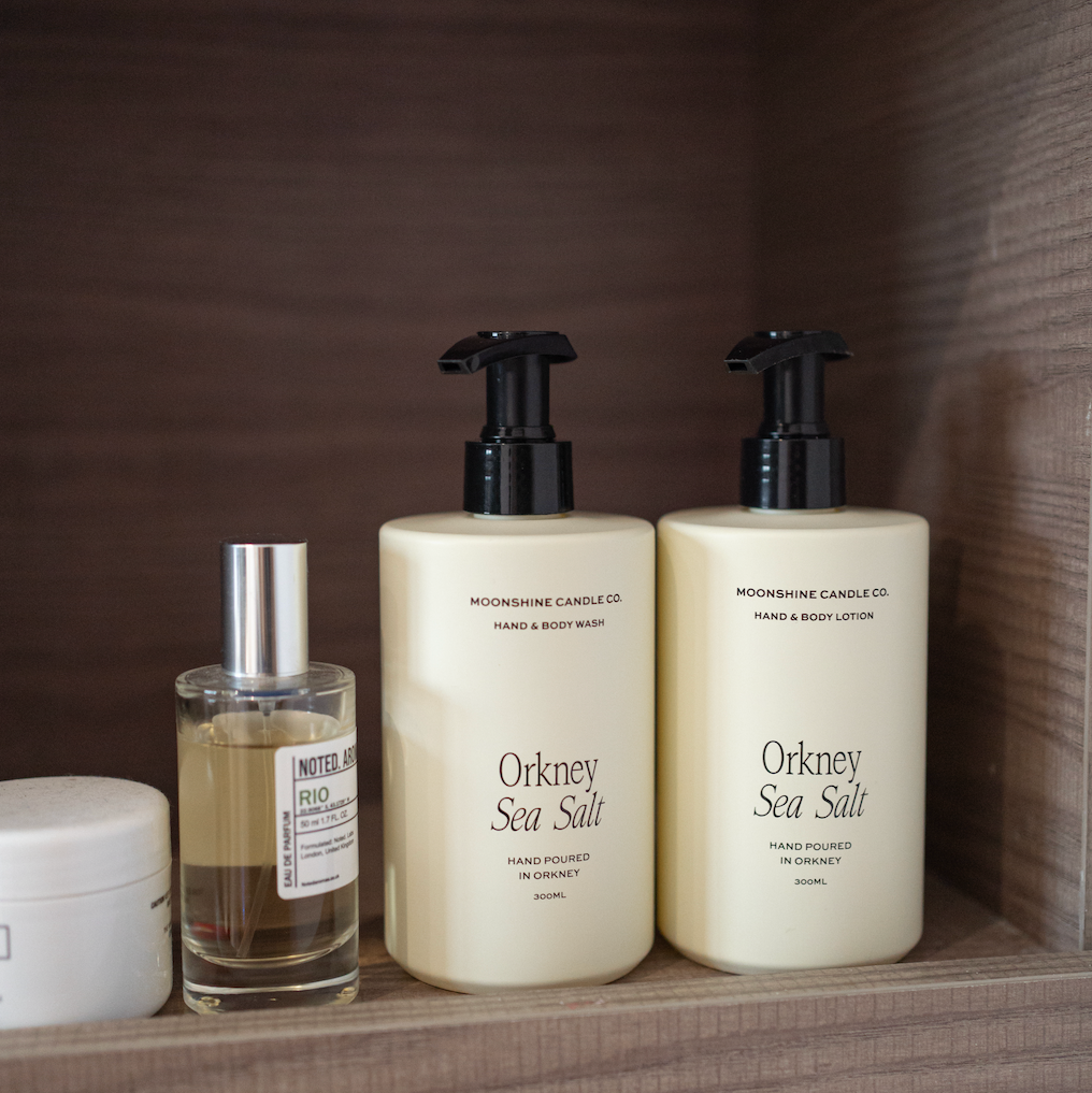 Three skincare products on a wooden shelf with 'Orkney Sea Salt' branding.