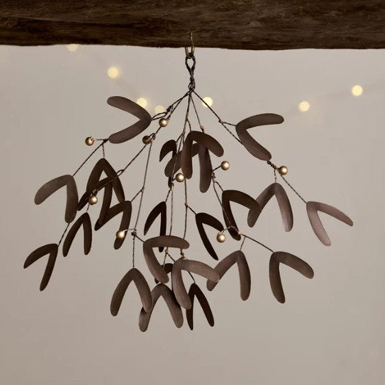 Avni Mistletoe decoration in antique finish brass by Nkuku, featuring detailed brass craftsmanship and festive design.