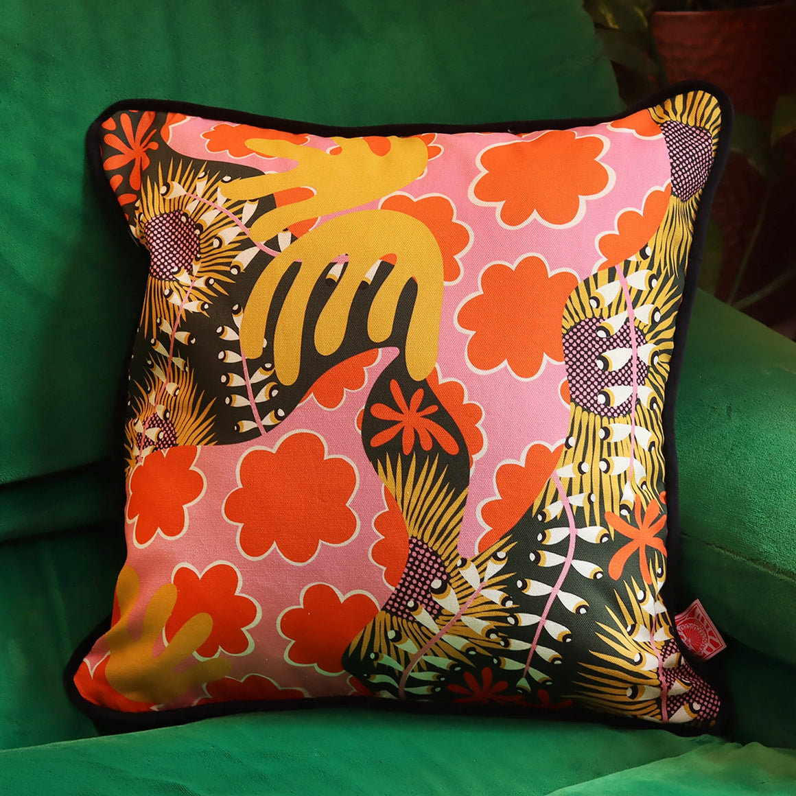 Funky botanical cushion cover by The Neighbourhood Threat Limited featuring vibrant floral and leaf patterns on soft fabric.