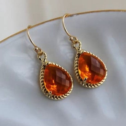 Burnt orange amber earrings by Faire-LAALee featuring handcrafted design and warm, vibrant gemstone accents.